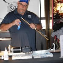 Working on a cue shaft at a shop event